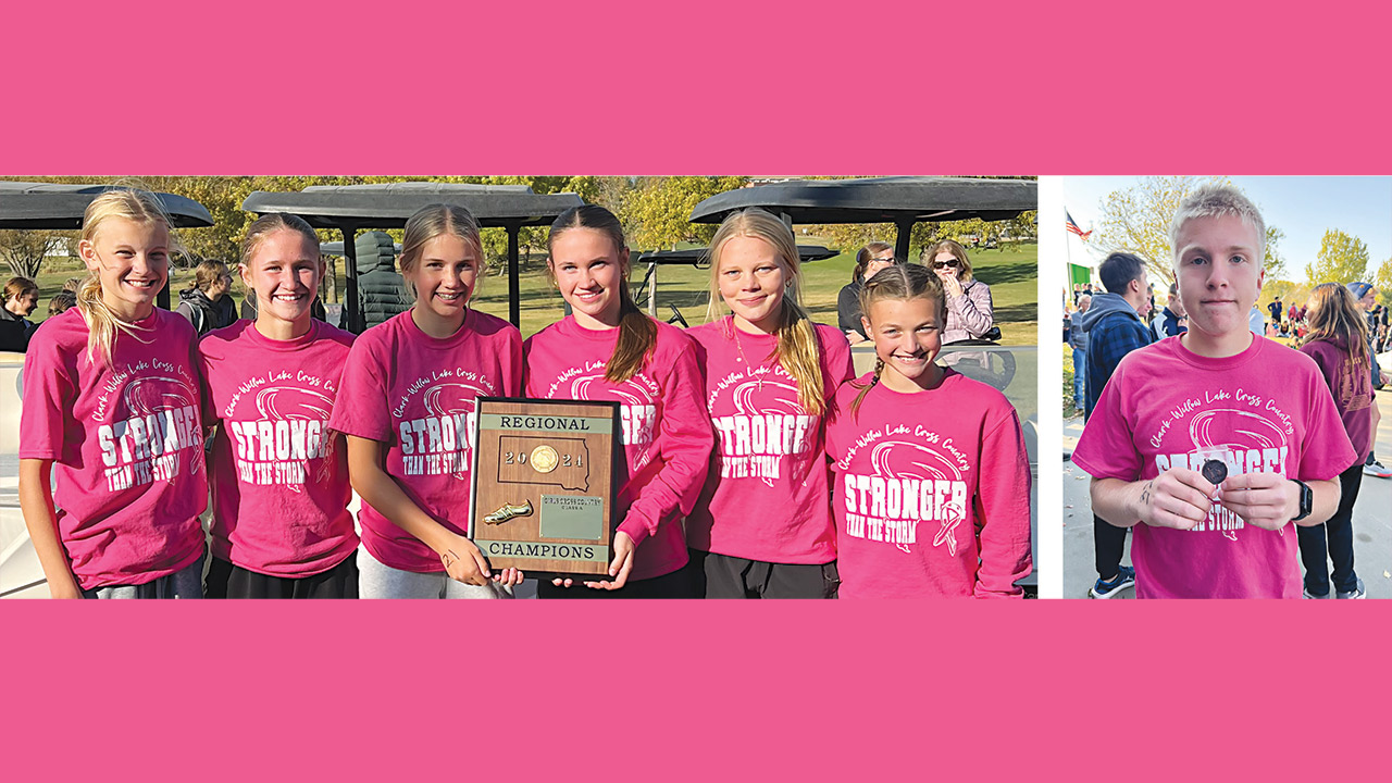 seven teens in hot pink shirts lined up with plaque