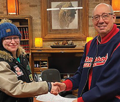 Karli Paulson and Bill Krikac shake hands