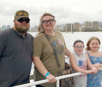 Waldow family along railing with water in background