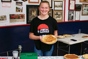 teen female holding a pizza