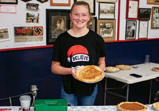 teen female holding a pizza