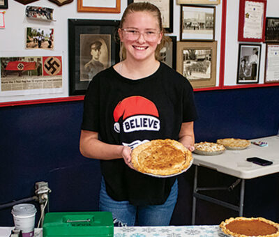 teen female holding a pizza