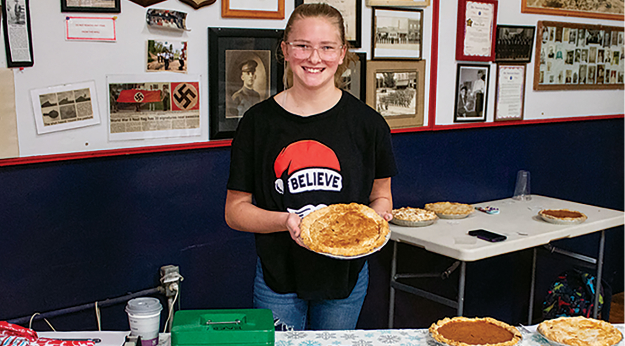 teen female holding a pizza