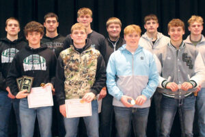 group of male teens holding awards