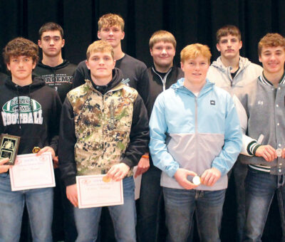 group of male teens holding awards