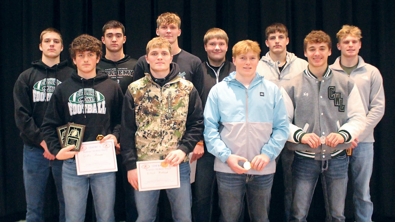 group of male teens holding awards