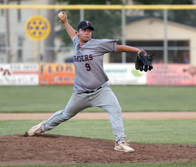 adult male baseball player pitching