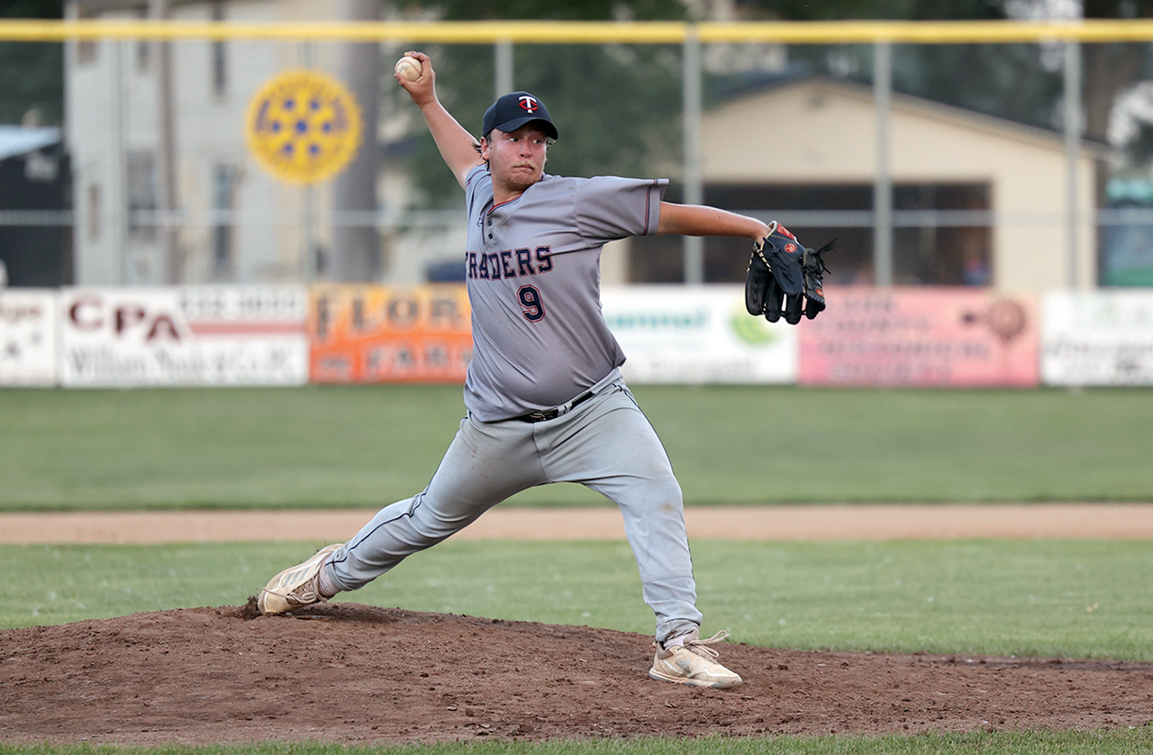 adult male baseball player pitching