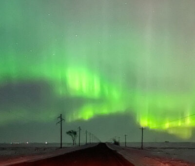 northern lights in green across the sky