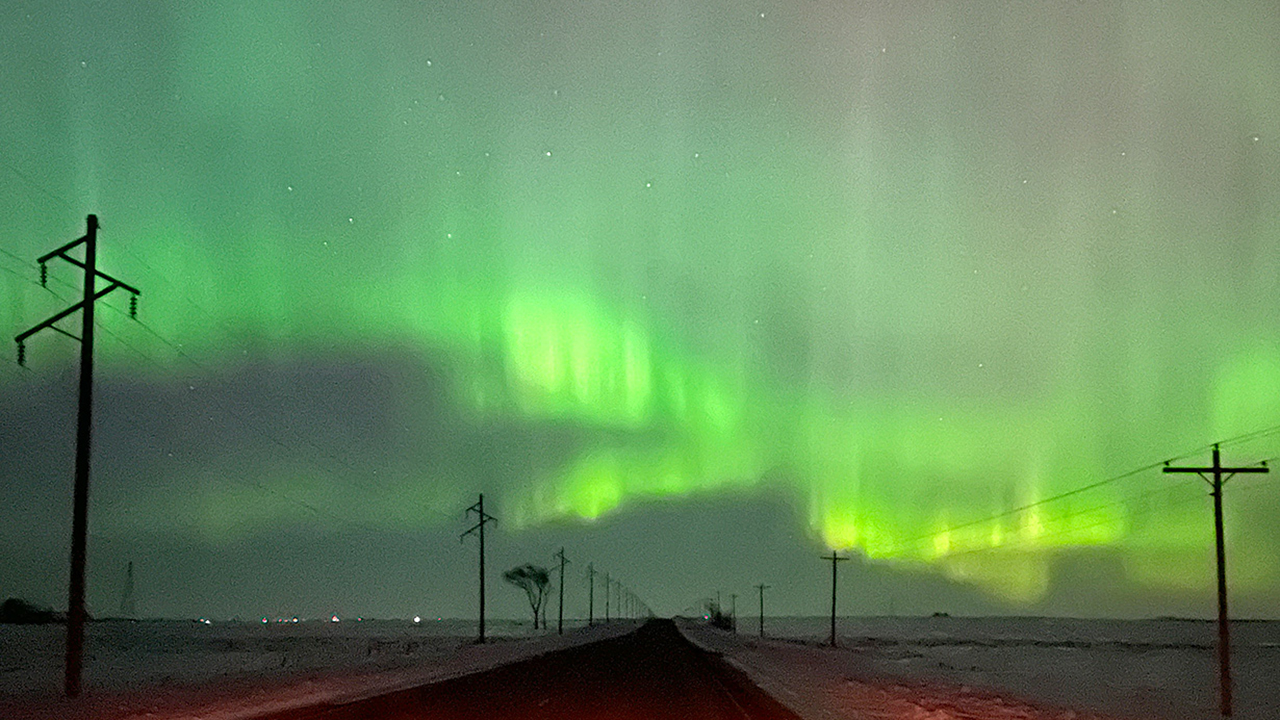 northern lights in green across the sky