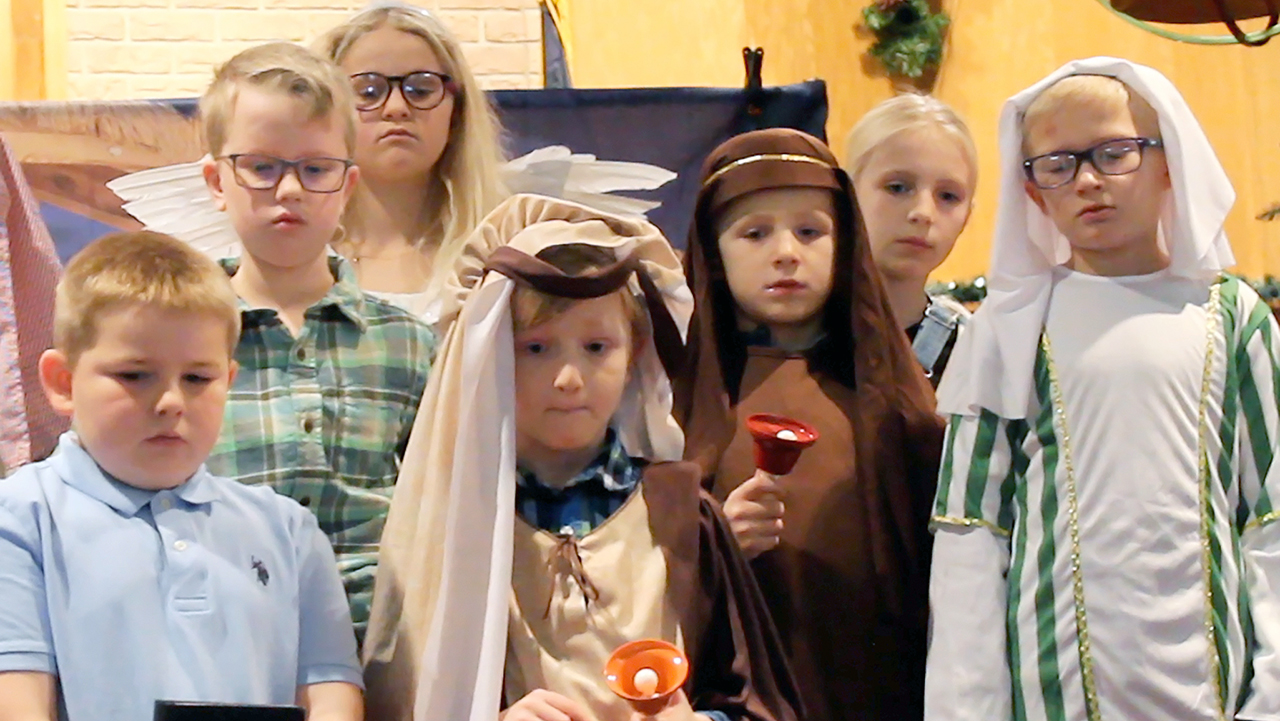 several young children dressed in nativity or nice clothing