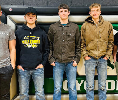 senior wrestlers, four teenage boys and one teenage girl standing in a row