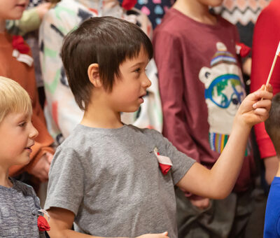 young child waving small American flag